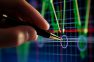 Ð¡hart on computer monitor, market's climbing, hand and pen pointer