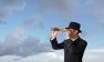 Man looking through telescope